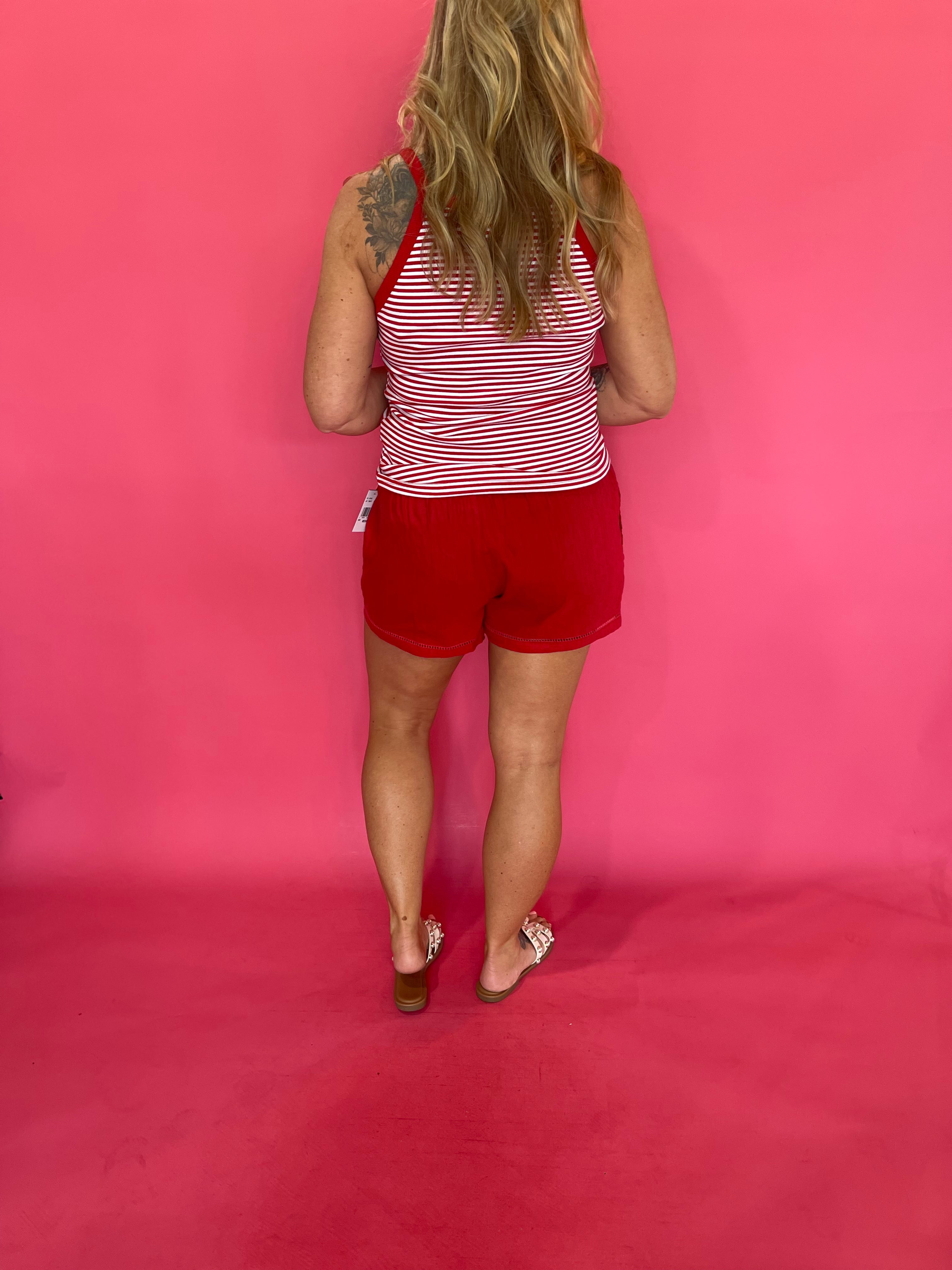 Side view showing the flowy linen blend drape of the red lattice trim summer shorts
