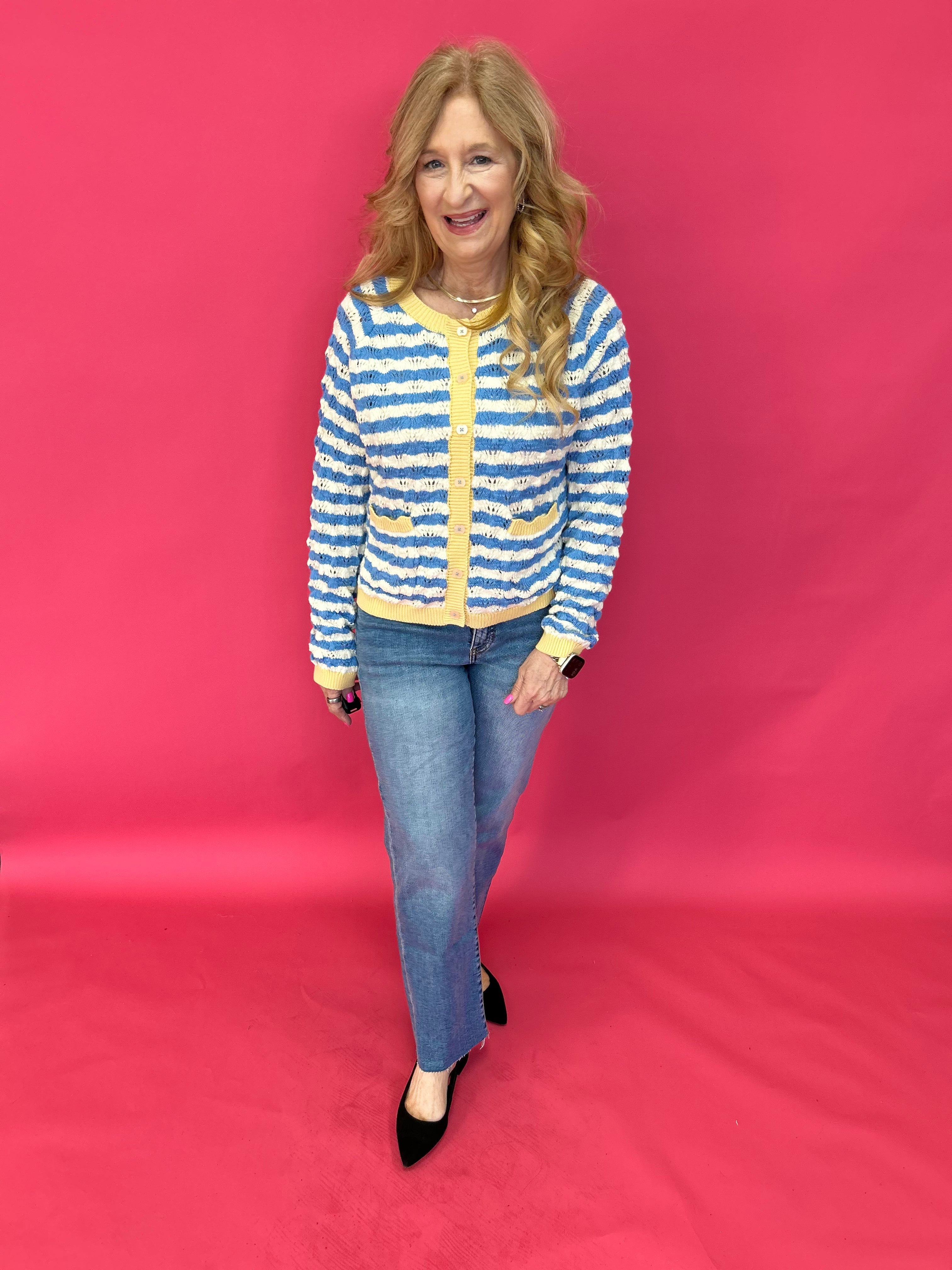 Close-up of the raw hem edge at the ankle on the medium wash high rise straight leg jeans