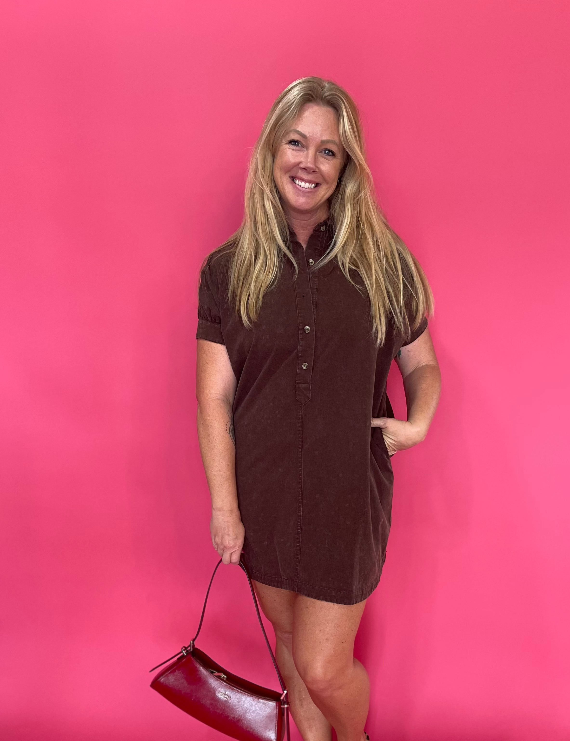 Woman wearing a bark brown mineral washed button front mini shirt dress with sneakers