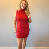 Woman wearing a red ribbed knit sleeveless midi sweater dress with a crew neckline and tall boots