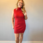 Back view of the red ribbed knit sleeveless sweater dress showing the straight midi silhouette
