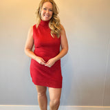 Close-up of the ribbed knit texture and crew neckline on the red sleeveless sweater dress