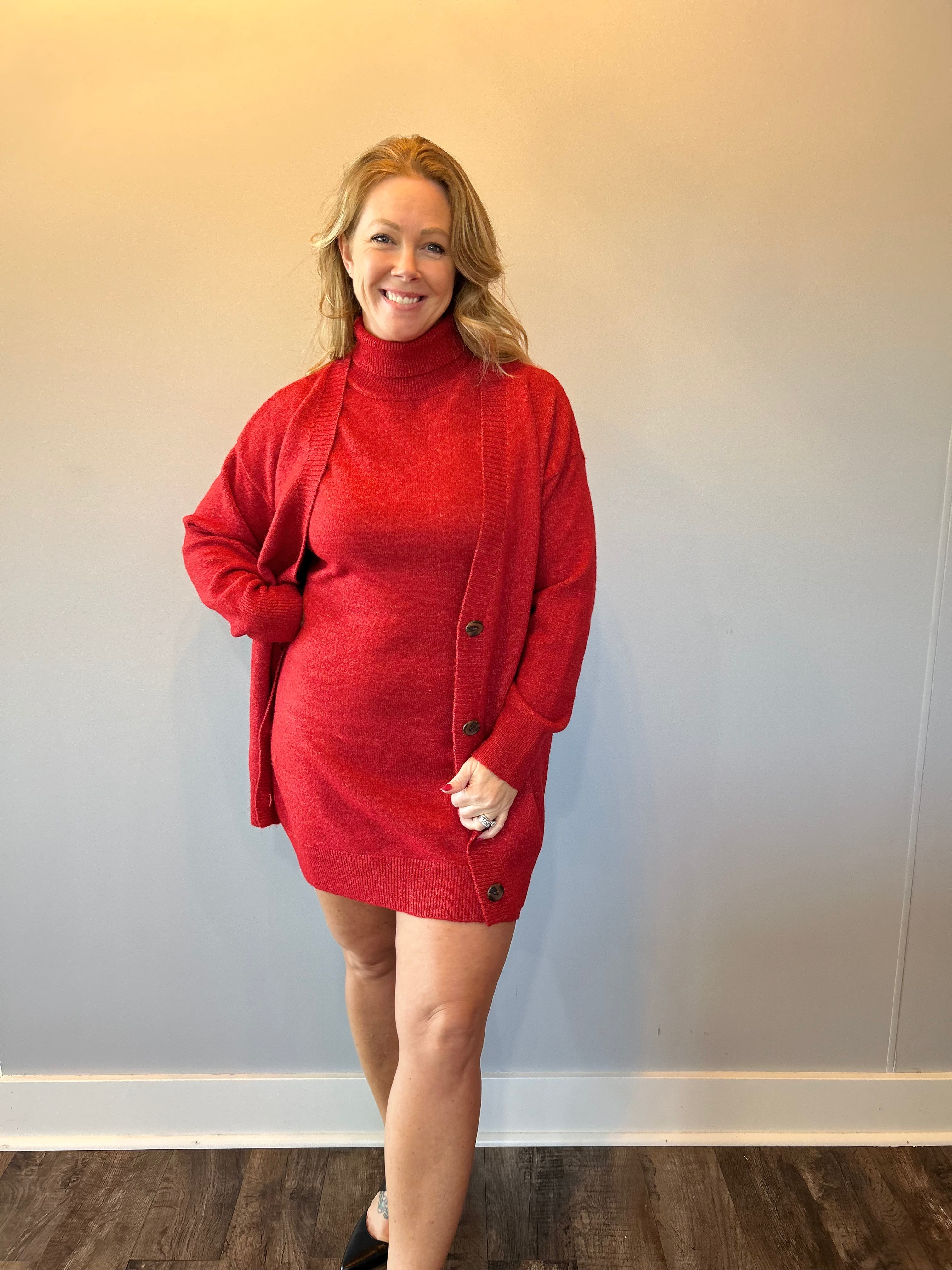 Full length view of the red sleeveless sweater dress styled on its own without layers