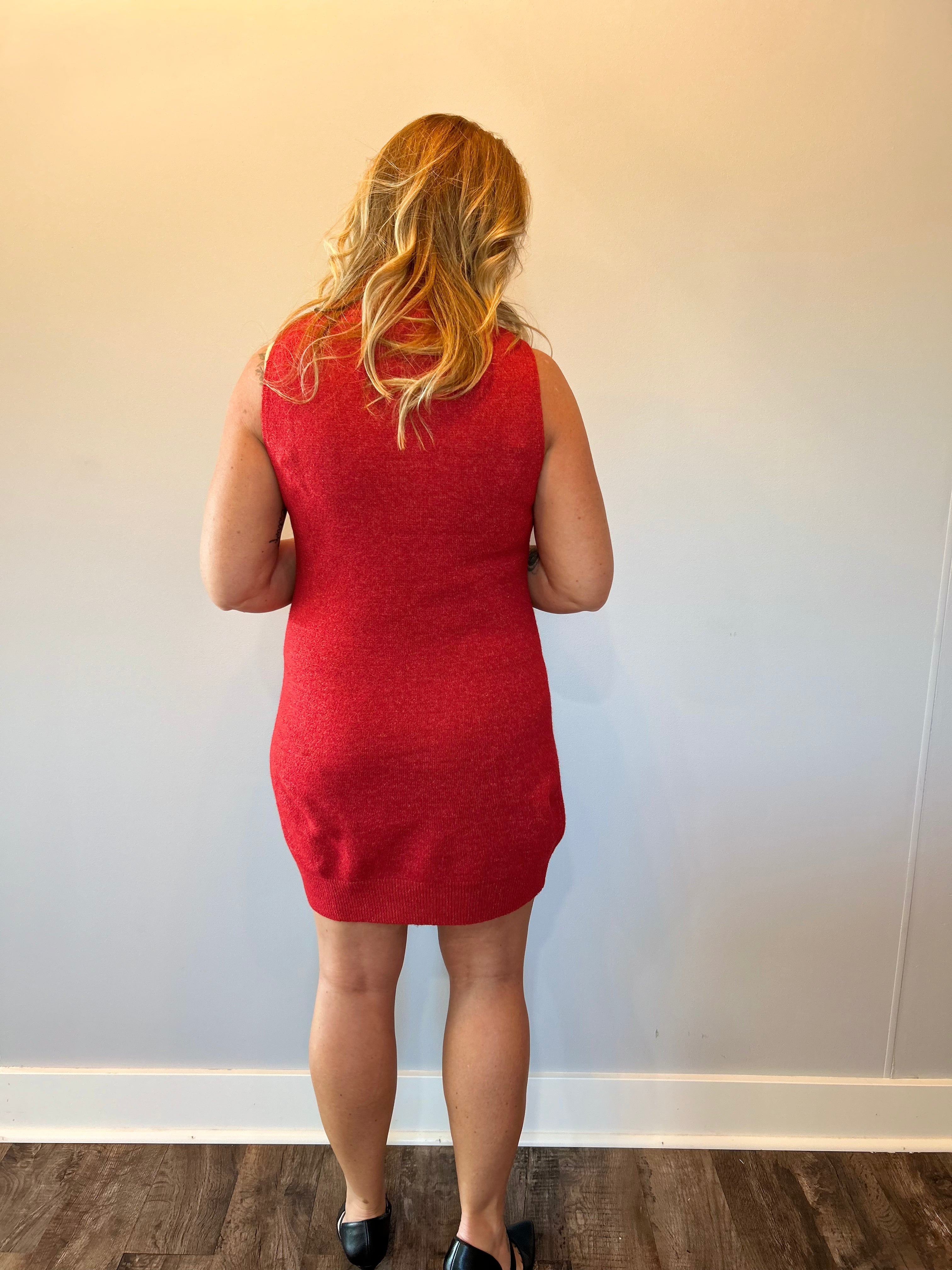 Flat lay of the red ribbed sleeveless sweater dress showing the crew neckline and midi length