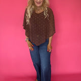 Back view of the brown dot mesh poncho showing the draped handkerchief hem falling past the hip