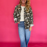 Back view of the green camo jacket showing the relaxed, oversized cut through the body
