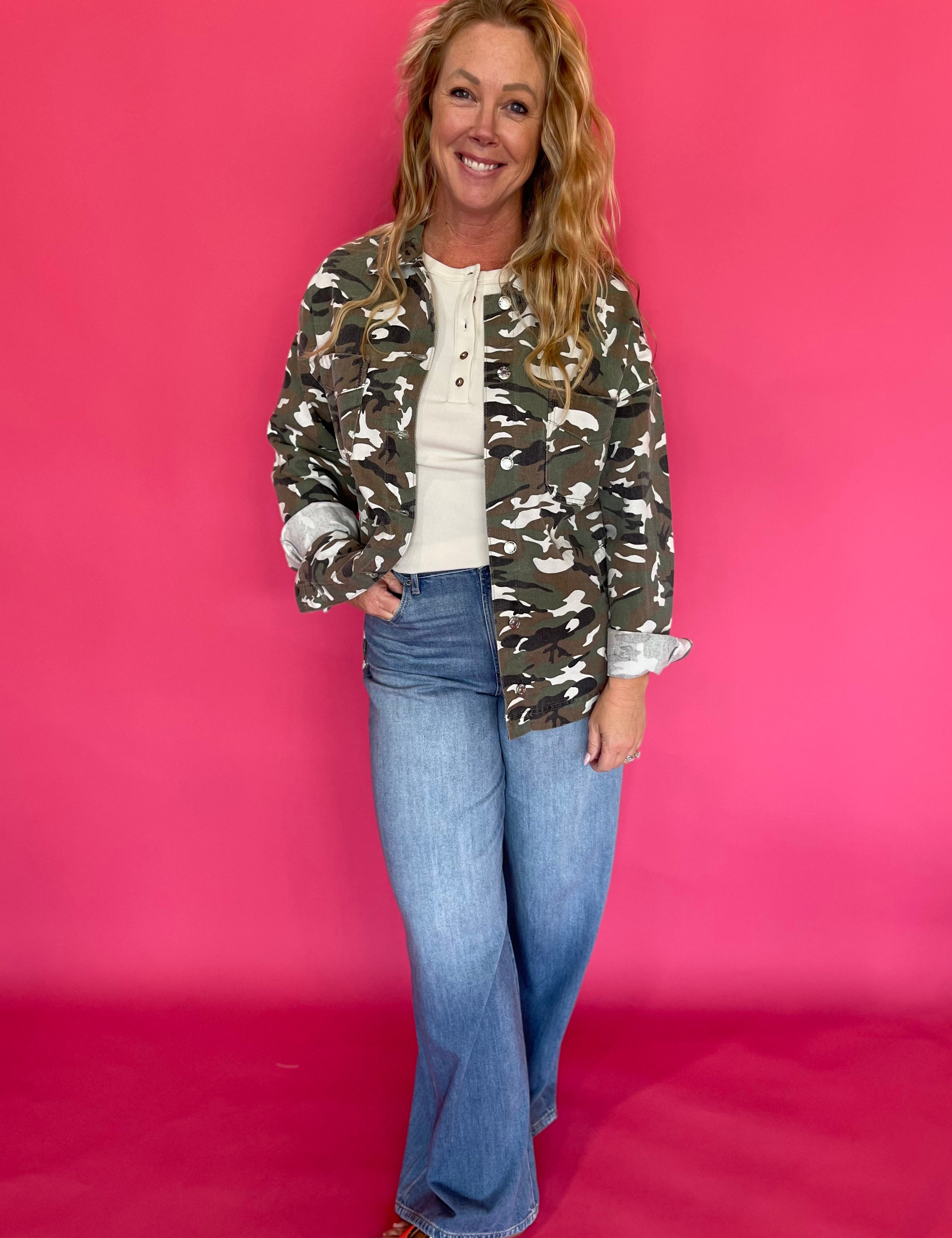 Back view of the green camo jacket showing the relaxed, oversized cut through the body