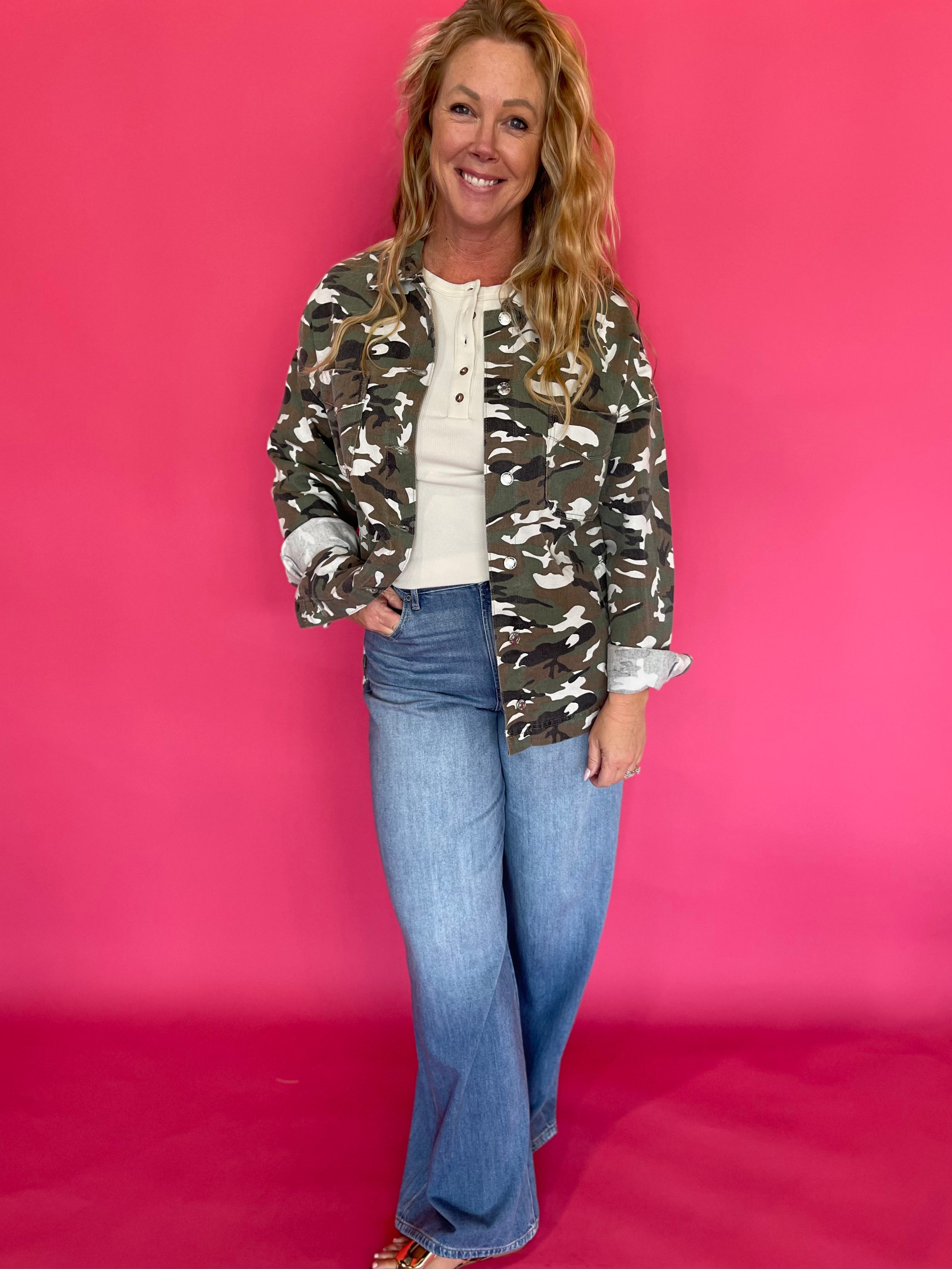Back view of the green camo jacket showing the relaxed, oversized cut through the body