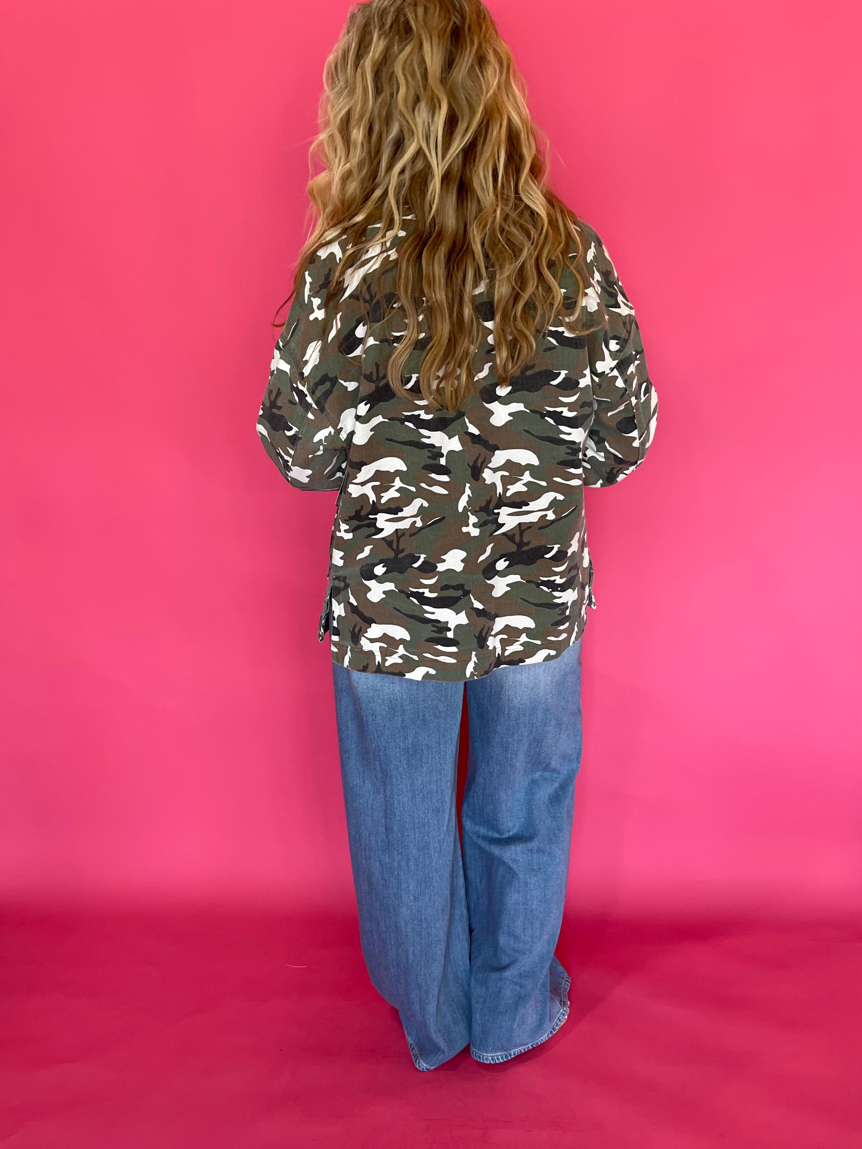 Detail of the button front and cuff on the loose fitting green camo print jacket