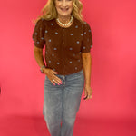 Close-up of the polka dot print and soft brown knit texture on the cocoa cardigan