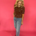 Side view showing the sleeve length and open front of the brown polka dot cardigan