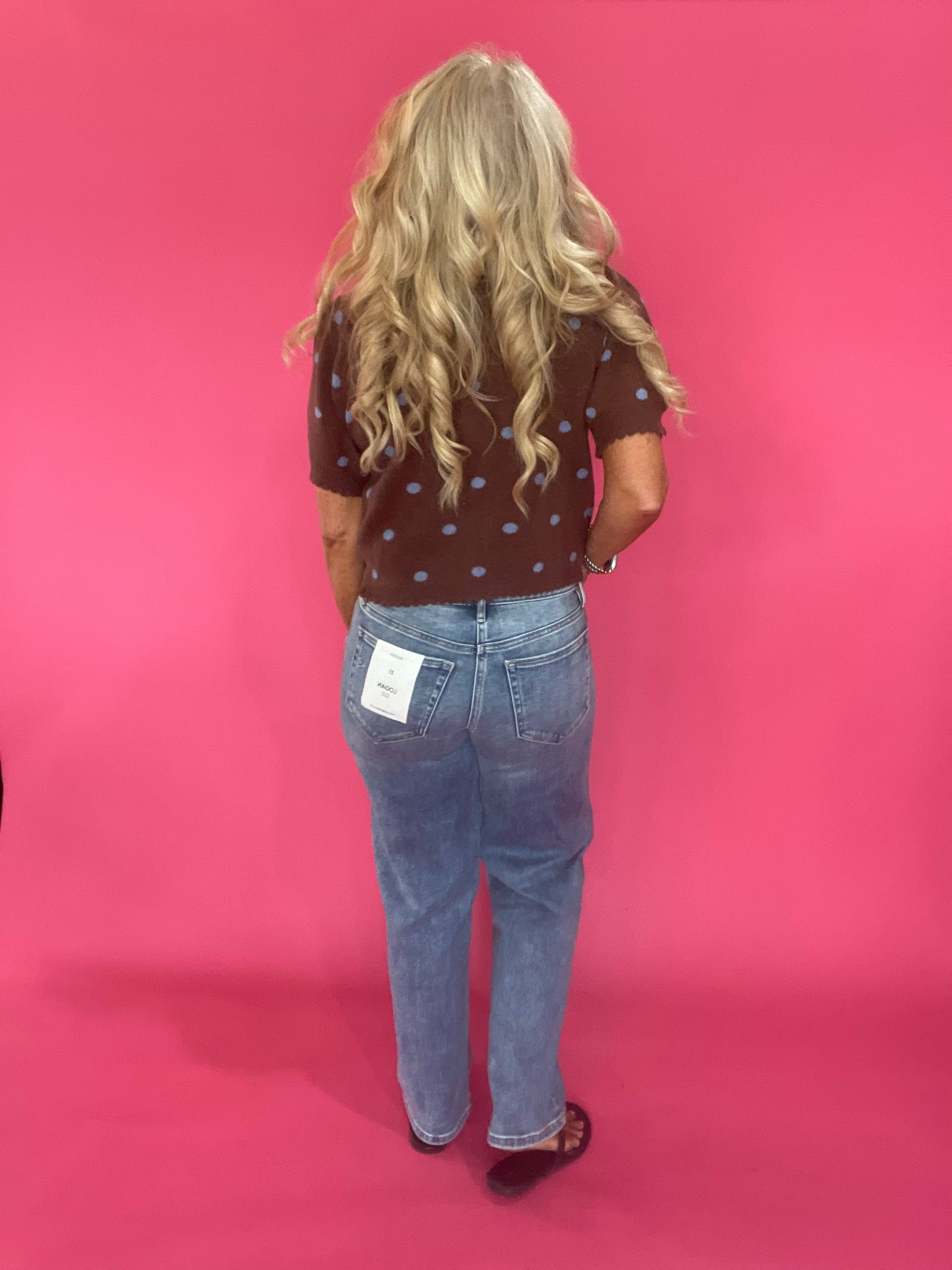 Full length view of the cocoa brown polka dot cardigan worn open with denim and booties