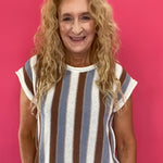 Woman wearing a blue and brown striped short sleeve knit sweater top with high waist jeans