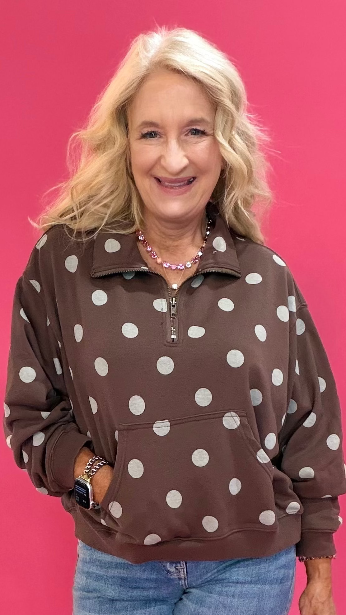 Woman wearing a brown mineral wash quarter zip pullover with polka dot texture over leggings and sneakers