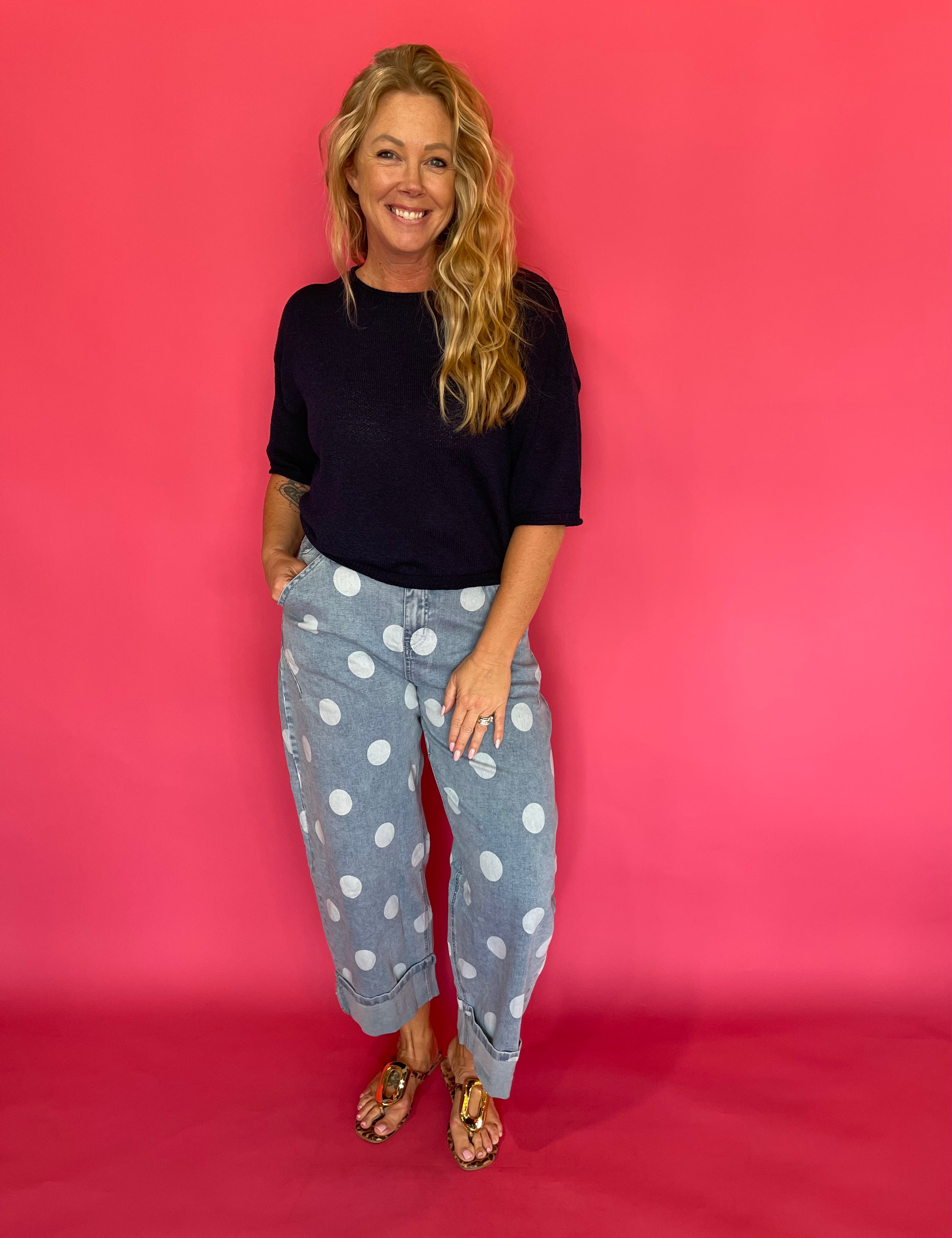 Back view of the light wash polka dot barrel jeans showing the high waist and pockets