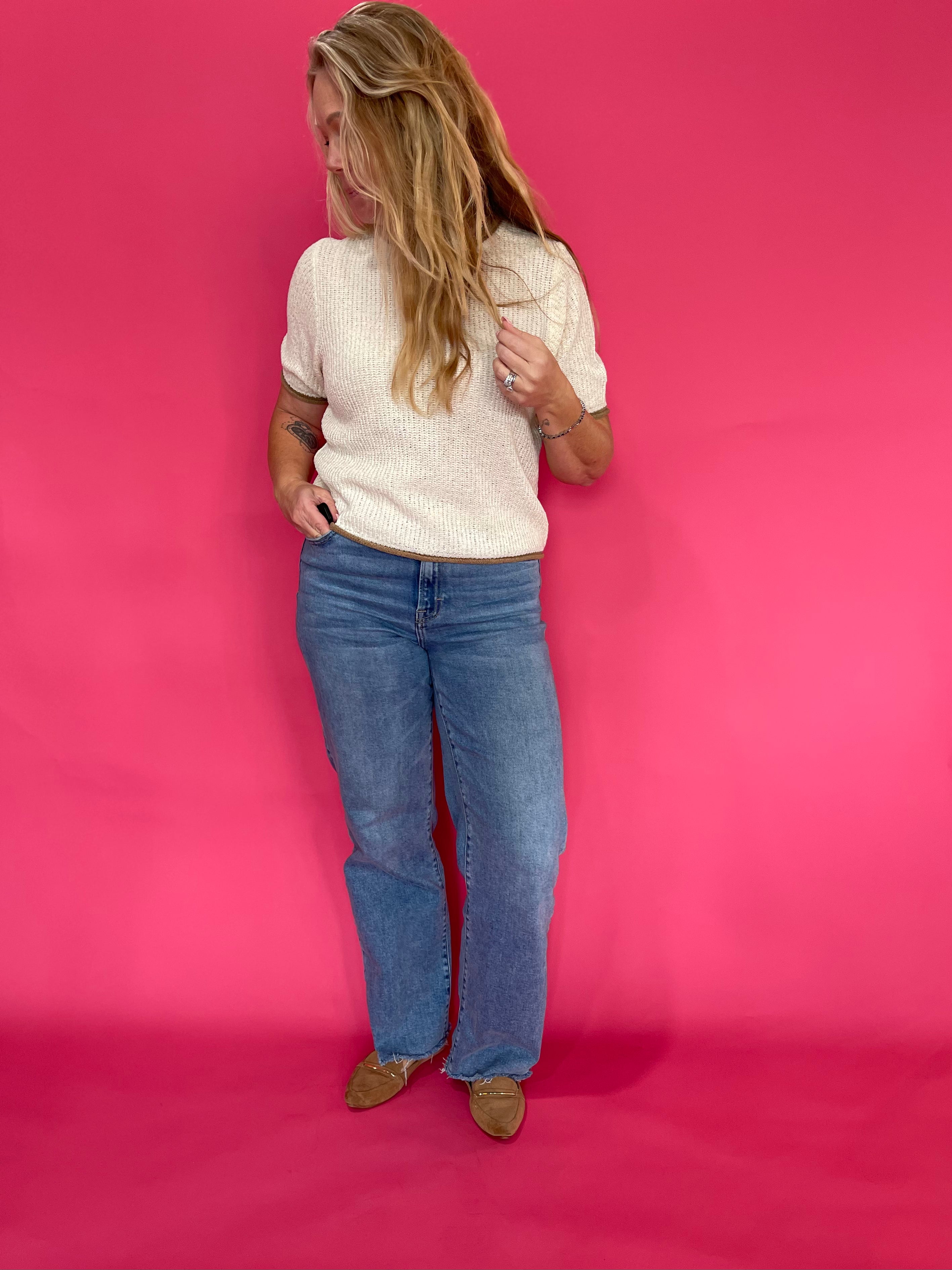 Close-up of the soft oatmeal knit texture and ribbed neckline on the cozy pullover sweater