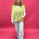 Back view of the chartreuse sherpa vest showing the relaxed layering fit through the body