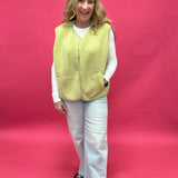 Back view of the chartreuse sherpa vest showing the relaxed layering fit through the body