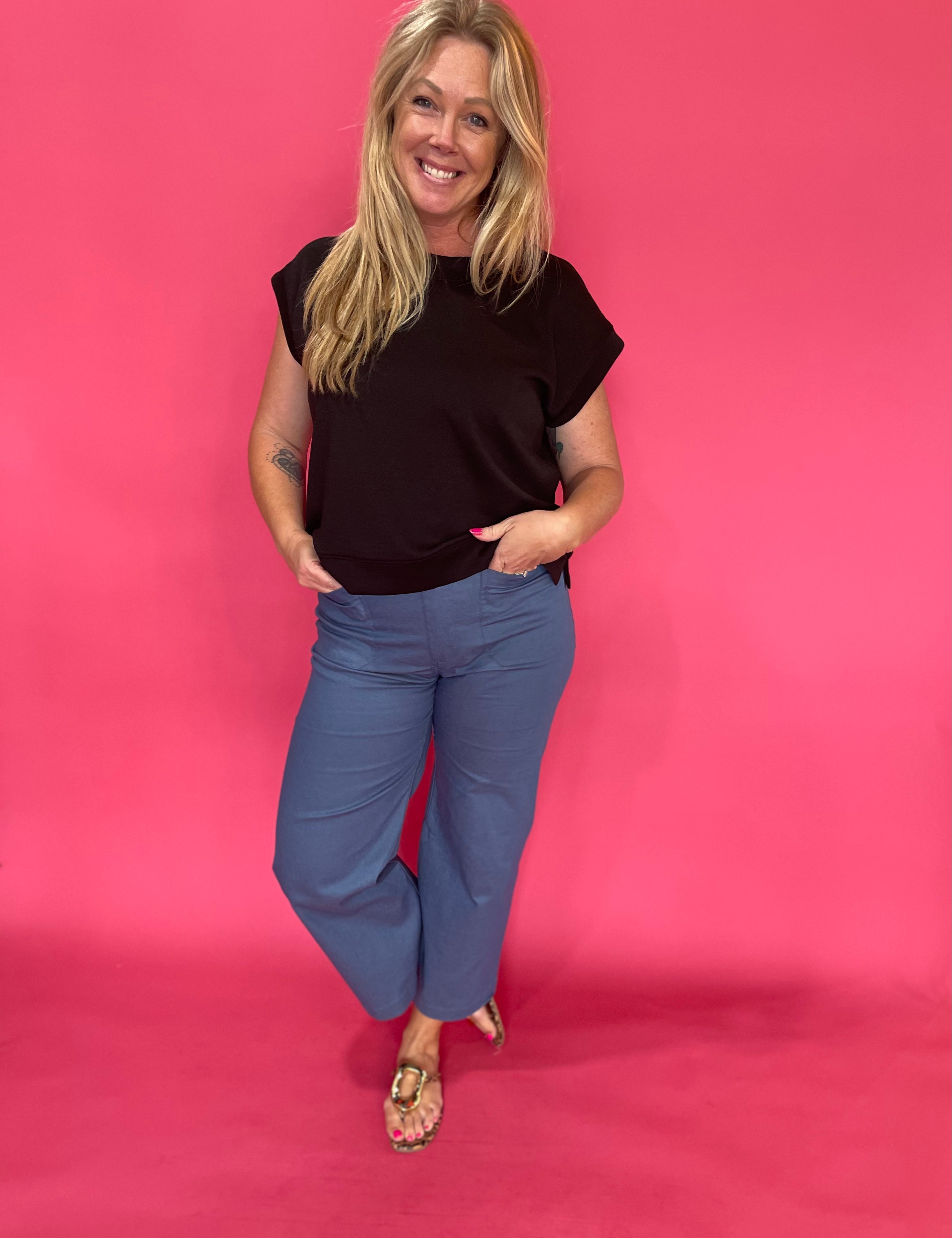 Back view of the denim blue cropped pants showing the high rise waist and cropped ankle hem