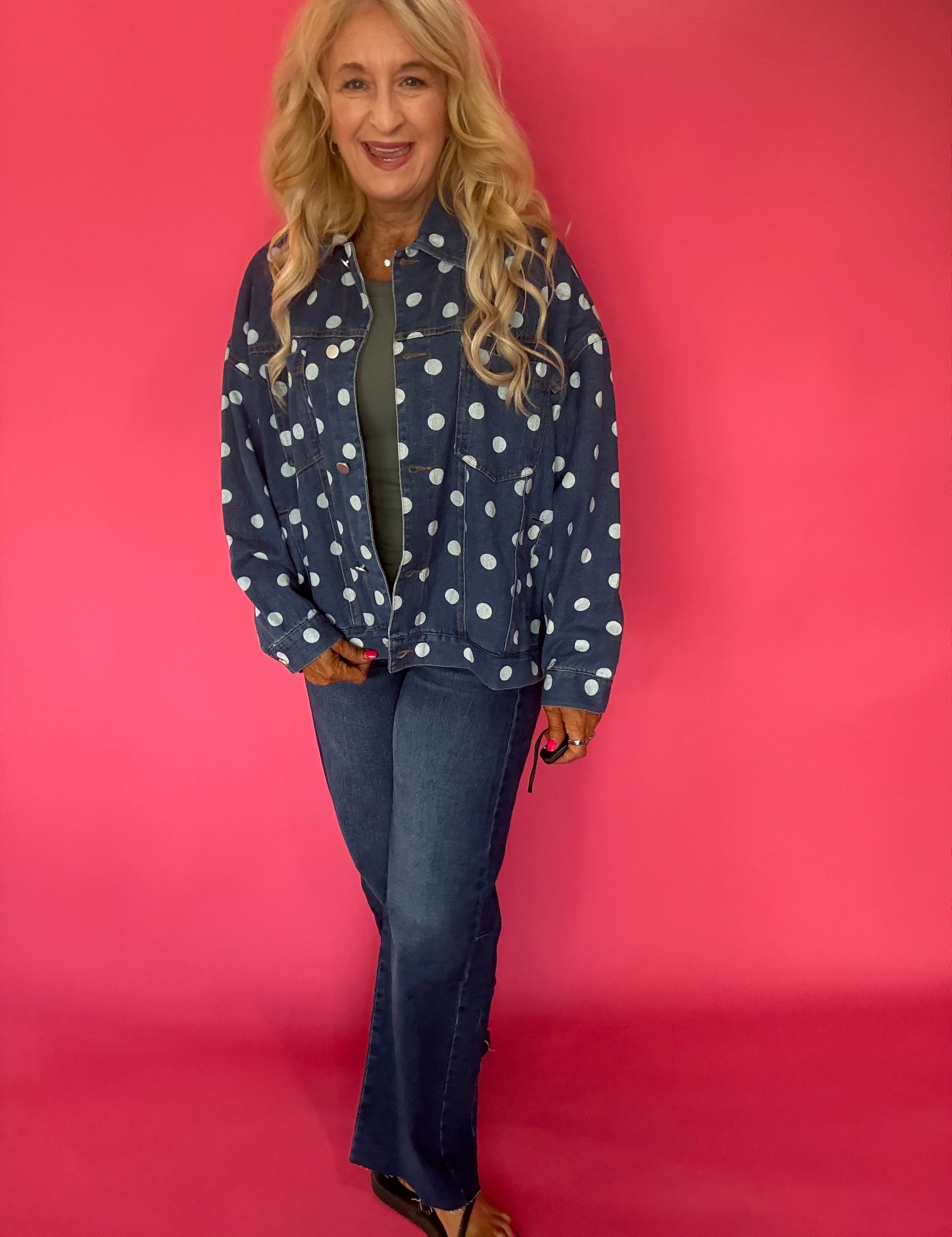 Back view of the oversized dark denim polka dot jacket showing the allover print and dropped shoulders
