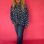 Back view of the oversized dark denim polka dot jacket showing the allover print and dropped shoulders