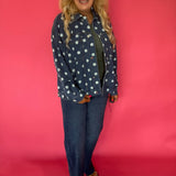 Close-up of the cream polka dot print and button front placket on the dark wash denim jacket