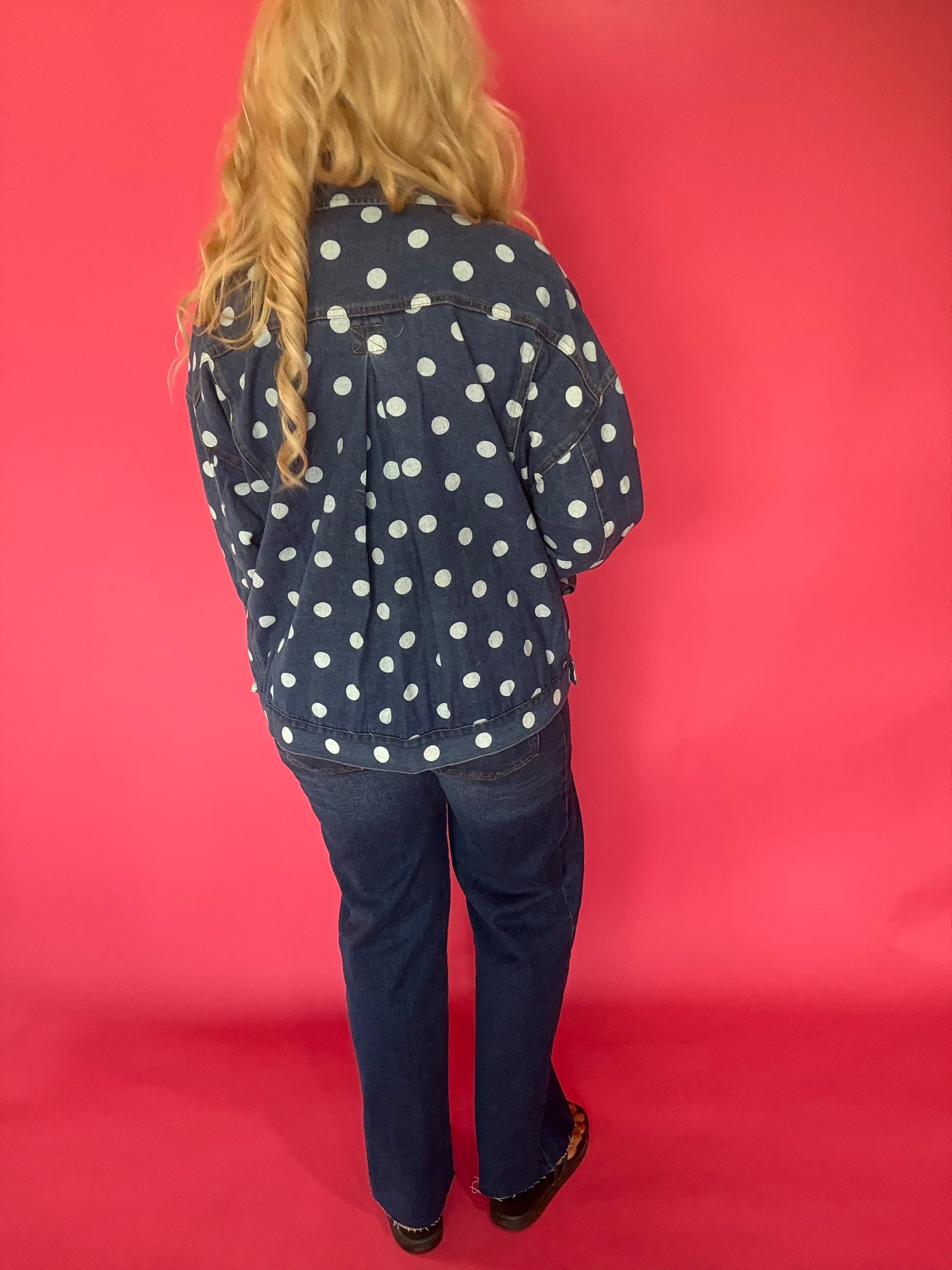 Side view showing the roomy oversized fit and classic collar of the dark denim dot jacket