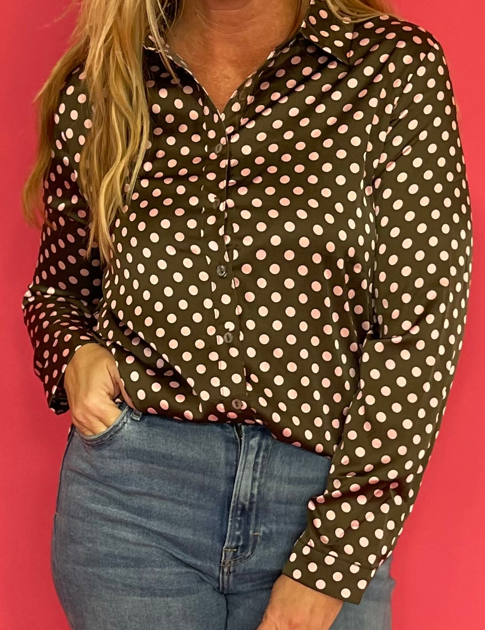 Back view of the olive satin polka dot shirt showing its relaxed button down cut