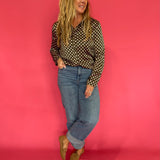 Detail of the cuff and button placket on the olive polka dot satin long sleeve shirt