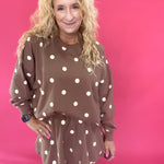 Side view showing the side pocket and elastic waist on the mocha polka dot pull-on skort