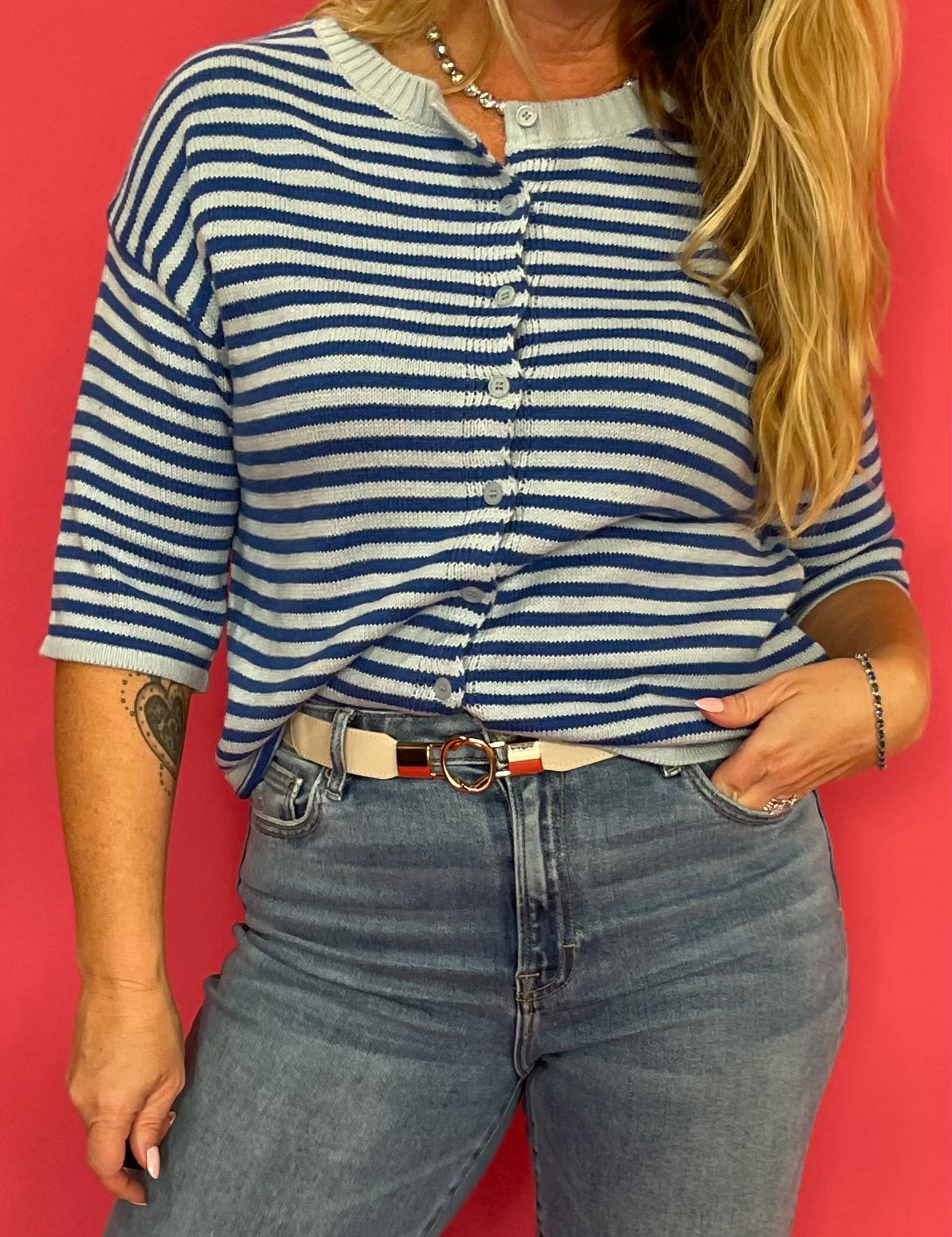 Back view of the cropped blue stripe fuzzy cardigan showing the short sleeves and relaxed fit