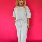 Back view of the striped knit lounge set showing the relaxed top and wide leg pant drape