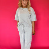 Back view of the striped knit lounge set showing the relaxed top and wide leg pant drape