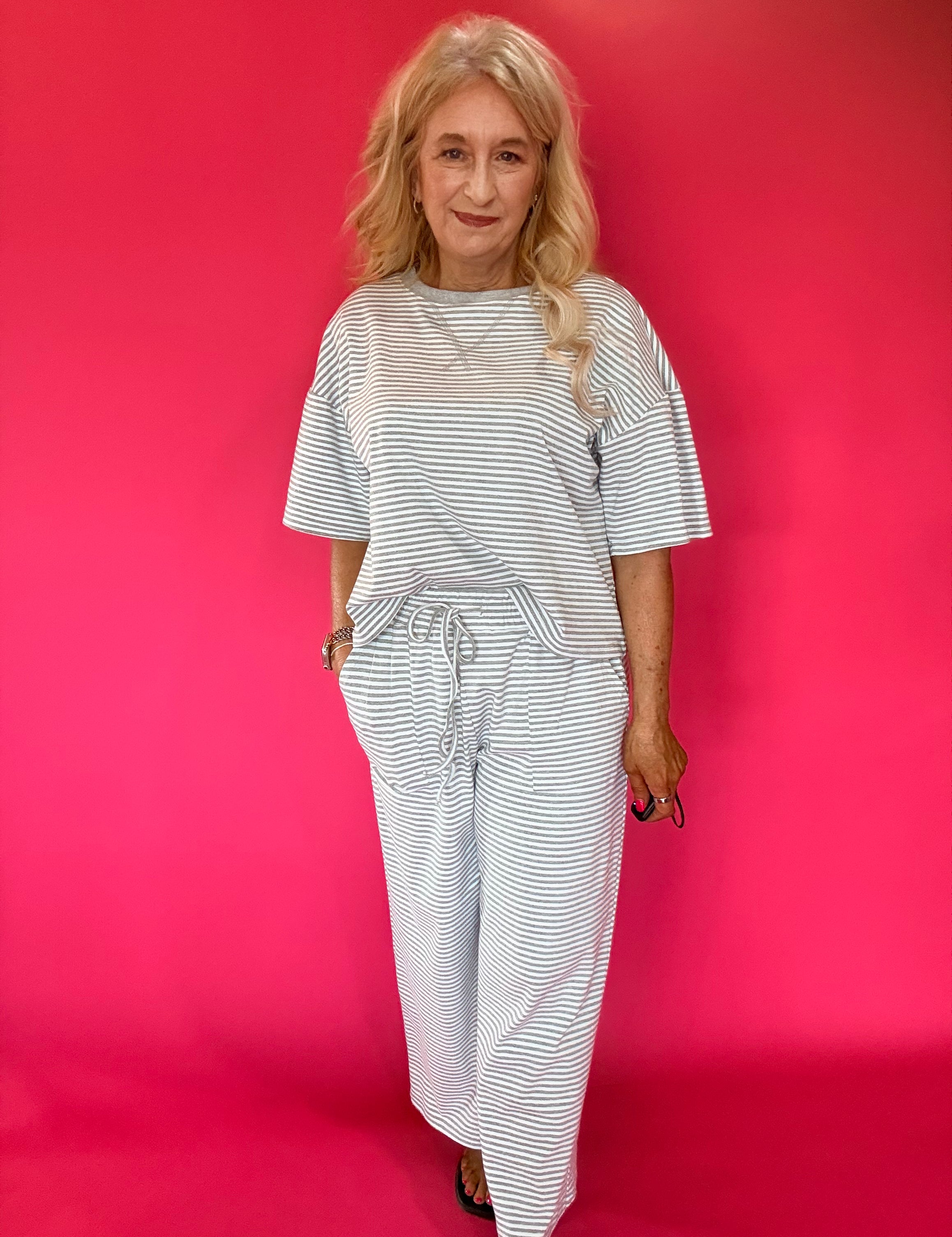 Back view of the striped knit lounge set showing the relaxed top and wide leg pant drape