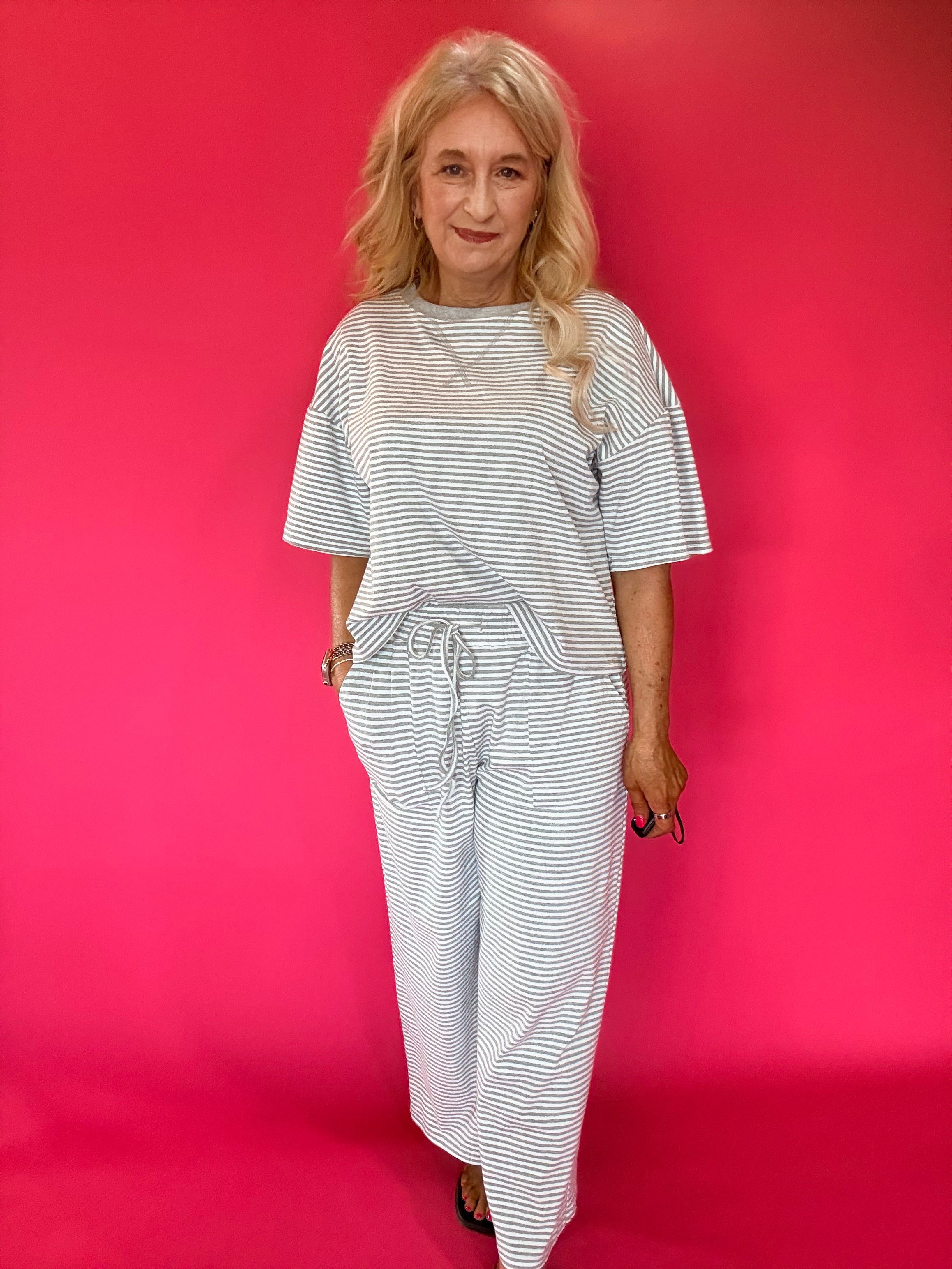 Back view of the striped knit lounge set showing the relaxed top and wide leg pant drape
