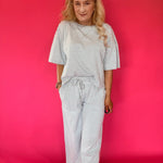 Close-up of the ribbed stripe knit texture and elastic drawstring waistband on the pants