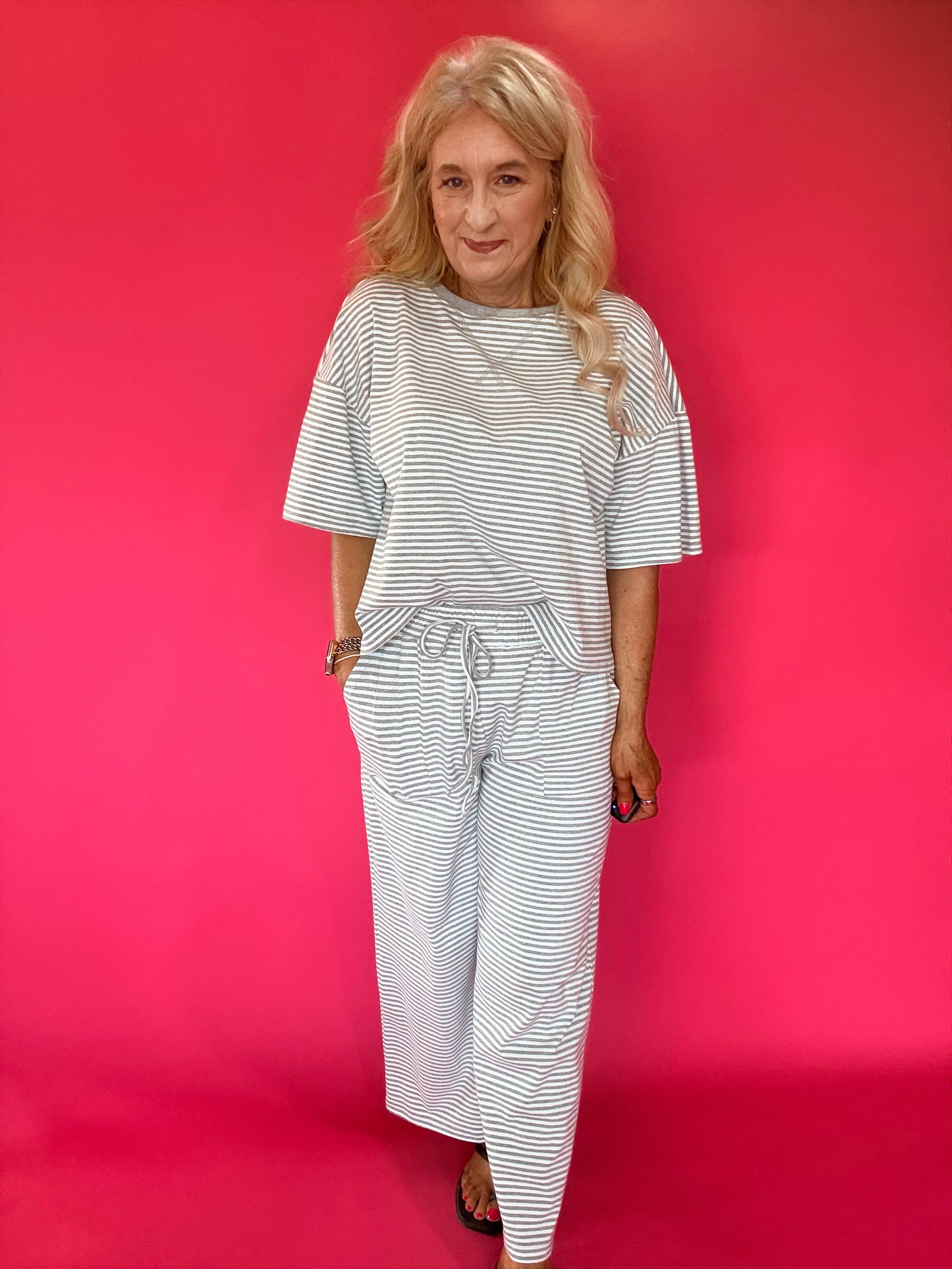 Close-up of the ribbed stripe knit texture and elastic drawstring waistband on the pants