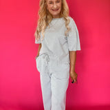 Detail of the short sleeve and neckline on the striped ribbed knit lounge set top
