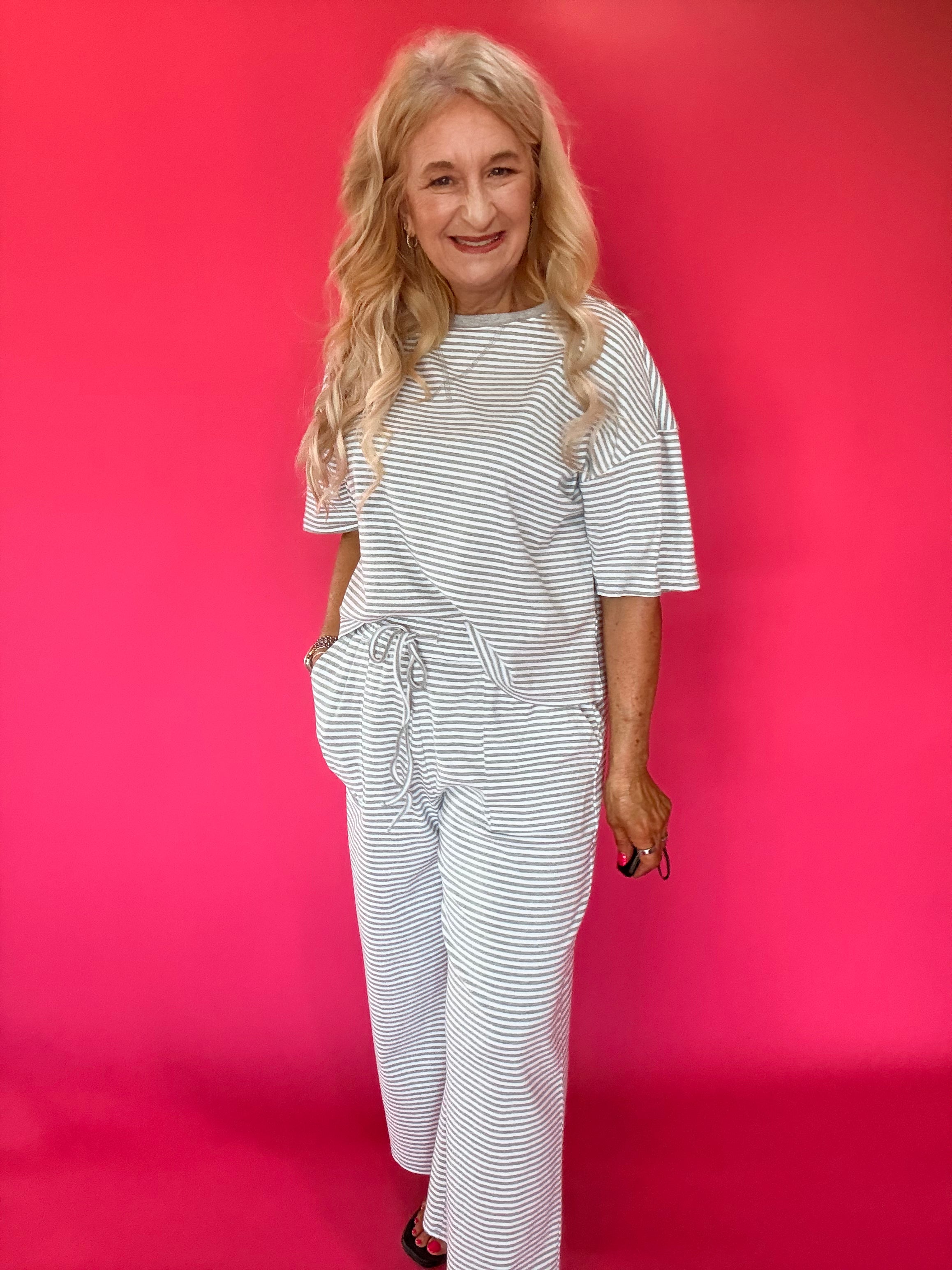 Detail of the short sleeve and neckline on the striped ribbed knit lounge set top