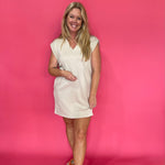 Detail of the smooth knit fabric on the almond V-neck shift dress