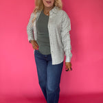 Full length view of the green ribbed knit crew neck tank tucked into high waisted denim