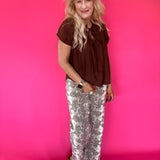 Side view showing the sleeve and easy relaxed shape of the brown lightweight woven blouse