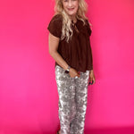 Side view showing the sleeve and easy relaxed shape of the brown lightweight woven blouse