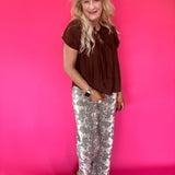 Side view showing the sleeve and easy relaxed shape of the brown lightweight woven blouse