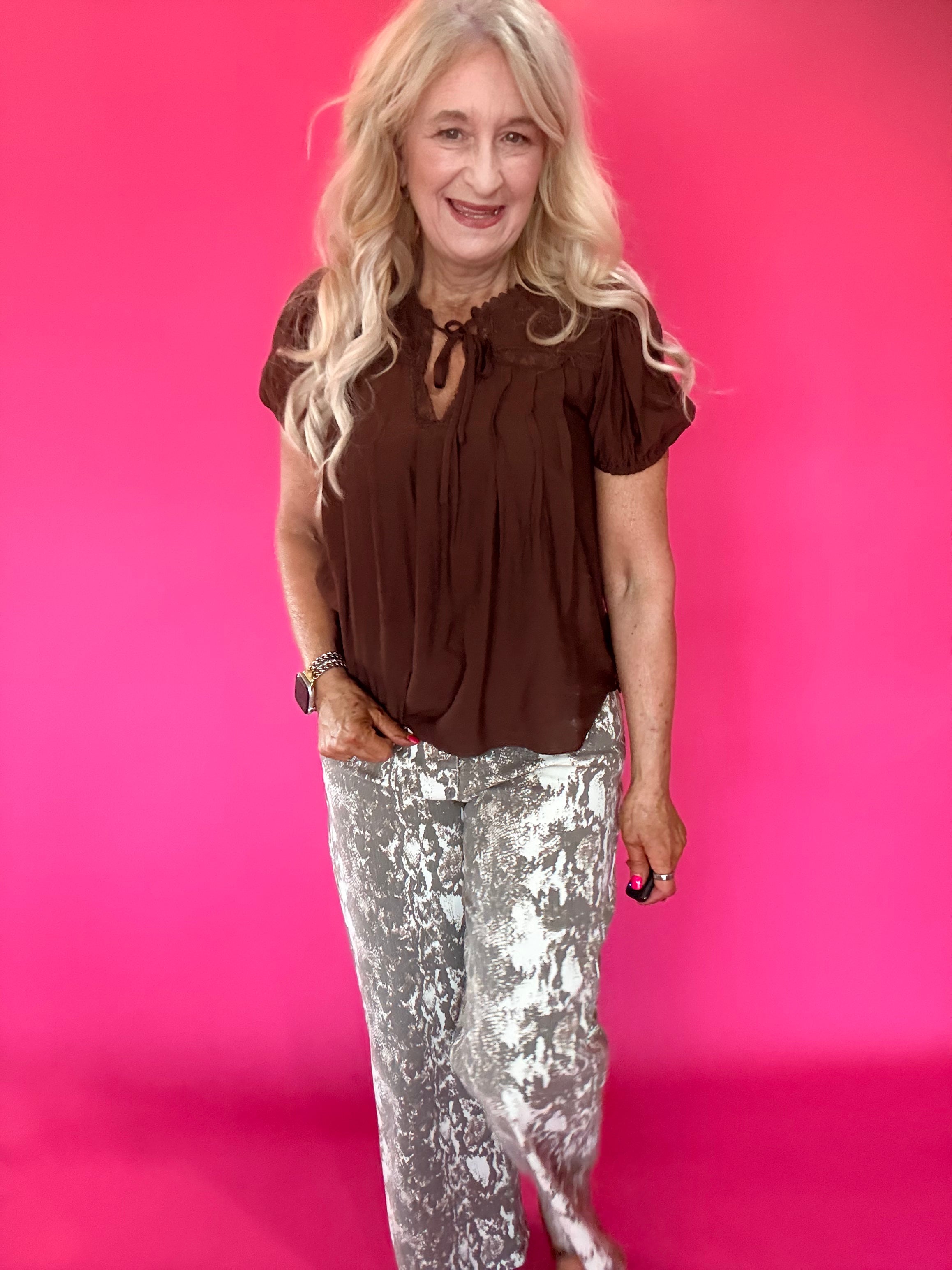 Brown woven blouse layered under a blazer with tailored trousers for a polished office look