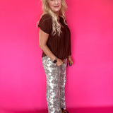 Full length view of the lightweight brown woven blouse tucked into high waisted denim