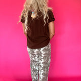 Flat lay of the brown lightweight woven blouse showing the sleeve length and hemline