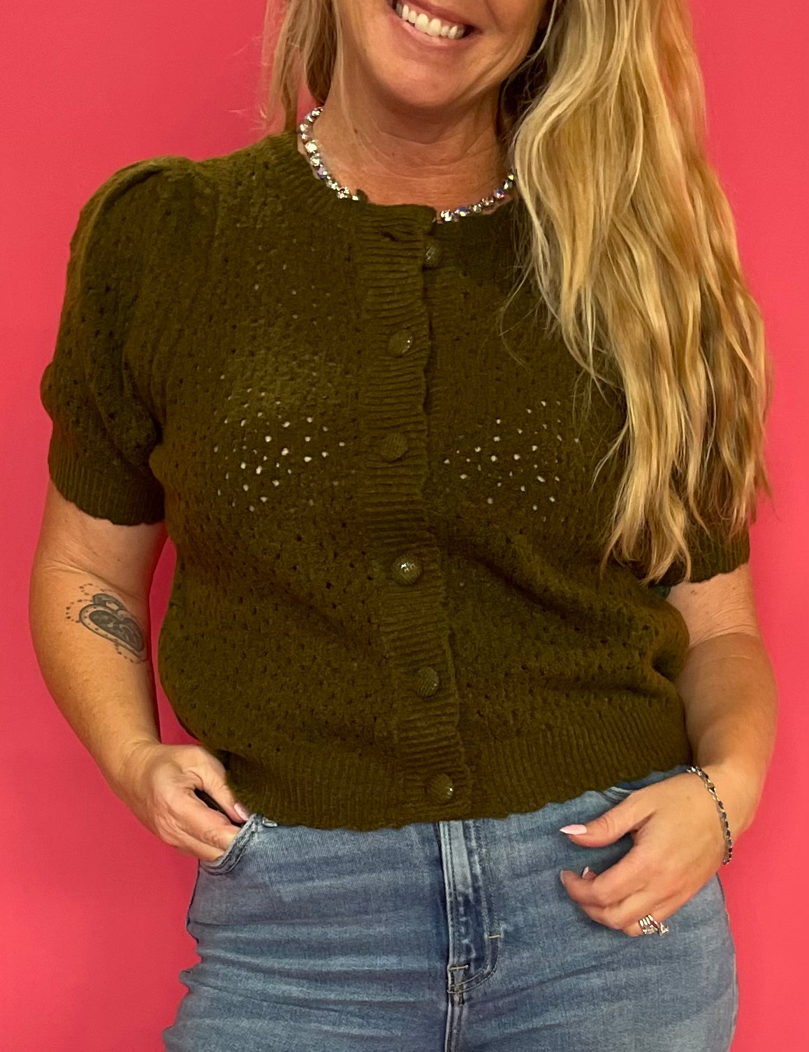 Back view of the olive boxy top showing the relaxed straight cut through the body and shoulders