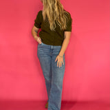 Close-up of the clean round neckline and soft knit texture on the olive everyday top