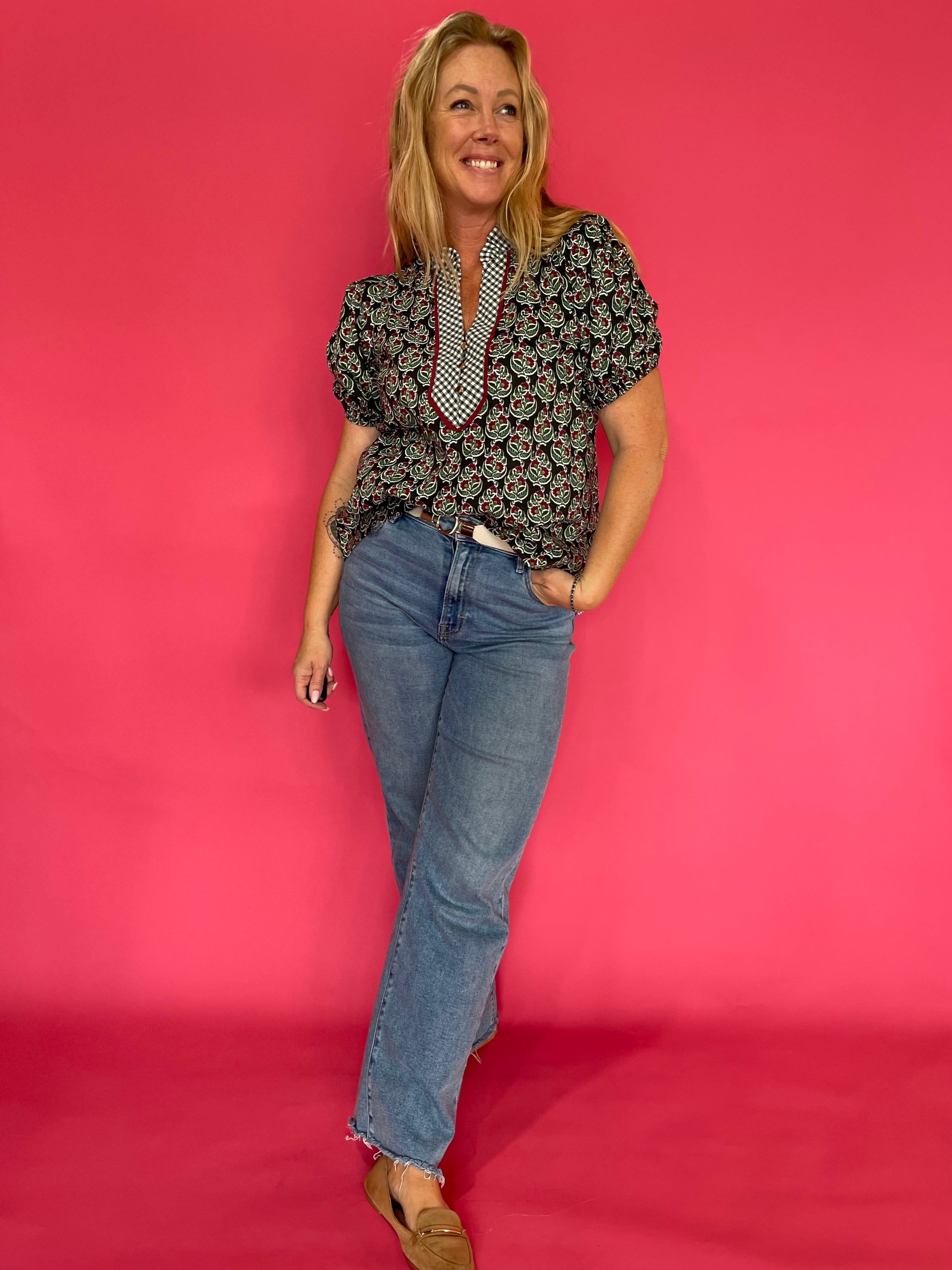 Detail of the neckline and shoulder on the dark green printed relaxed fit woven everyday top